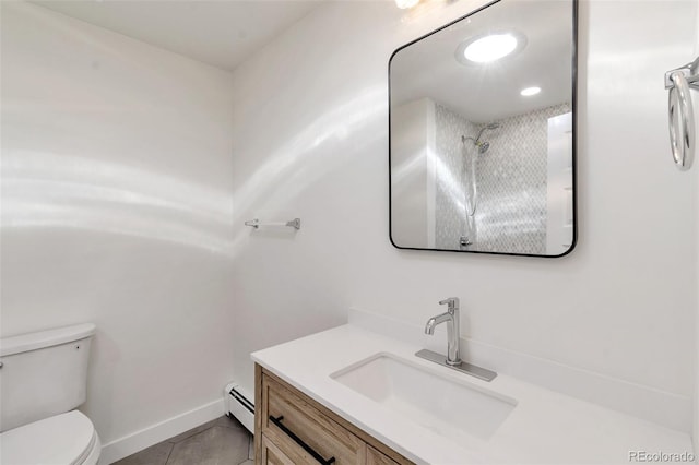 bathroom featuring toilet, tile patterned flooring, vanity, and a baseboard heating unit