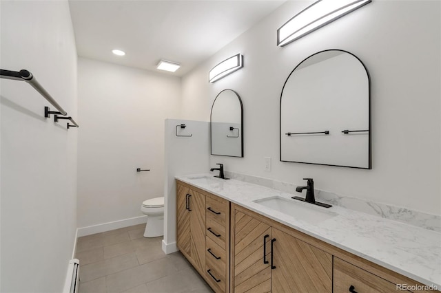 bathroom with tile patterned floors, vanity, a baseboard radiator, and toilet