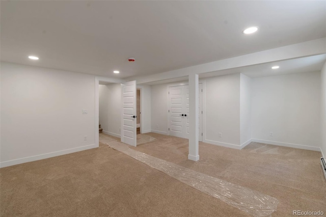 basement featuring light colored carpet