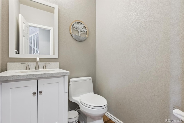 bathroom featuring toilet and vanity