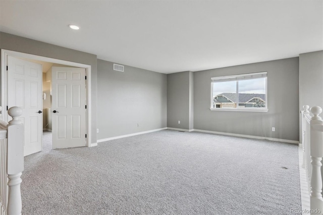 spare room featuring baseboards, carpet, recessed lighting, and visible vents