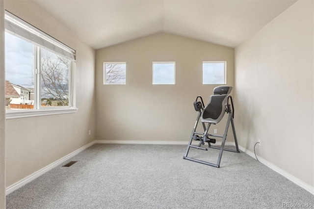 exercise room with baseboards, carpet, lofted ceiling, and visible vents