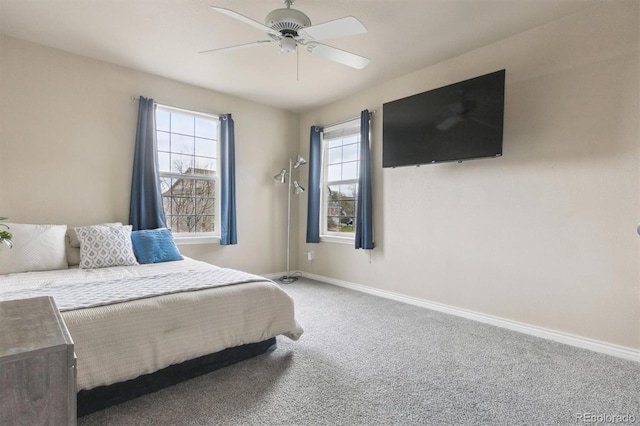 bedroom with baseboards, carpet flooring, and a ceiling fan