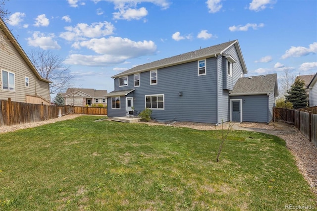 back of house with a lawn, a patio, and a fenced backyard