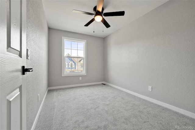 carpeted empty room featuring ceiling fan