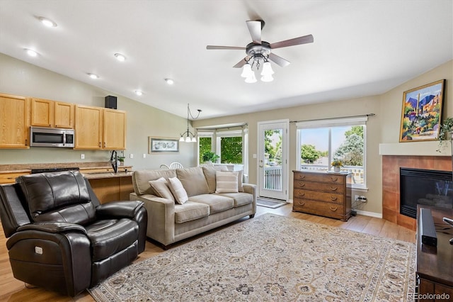 2169 Fox Fire St, Highlands Ranch, CO 80129 - living area with vaulted ceiling, light wood-style floors, ceiling fan, a fireplace, and recessed lighting