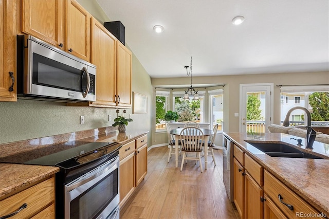 2169 Fox Fire St, Highlands Ranch, CO 80129 - kitchen featuring stainless steel appliances, light wood-type flooring, hanging light fixtures, light stone counters, and recessed lighting