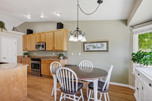 2169 Fox Fire St, Highlands Ranch, CO 80129 - kitchen with stainless steel appliances, vaulted ceiling, light wood-style floors, a chandelier, and light brown cabinetry
