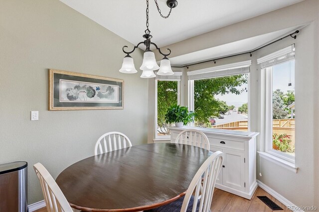 2169 Fox Fire St, Highlands Ranch, CO 80129 - dining area with a chandelier and light wood-style flooring