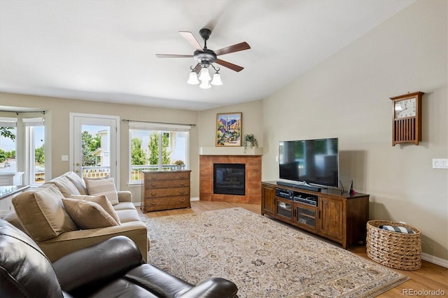 2169 Fox Fire St, Highlands Ranch, CO 80129 - living area with light wood finished floors, ceiling fan, a fireplace, and vaulted ceiling