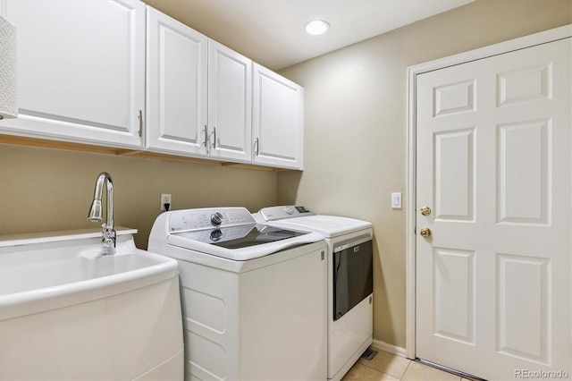 2169 Fox Fire St, Highlands Ranch, CO 80129 - laundry area with independent washer and dryer, cabinet space, light tile patterned floors, and recessed lighting