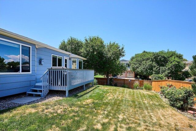2169 Fox Fire St, Highlands Ranch, CO 80129 - view of yard with a wooden deck
