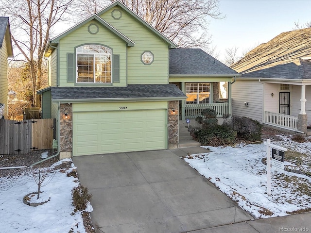 view of property with a garage and a porch