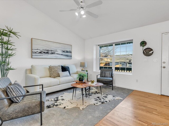 living room featuring ceiling fan, hardwood / wood-style floors, and vaulted ceiling