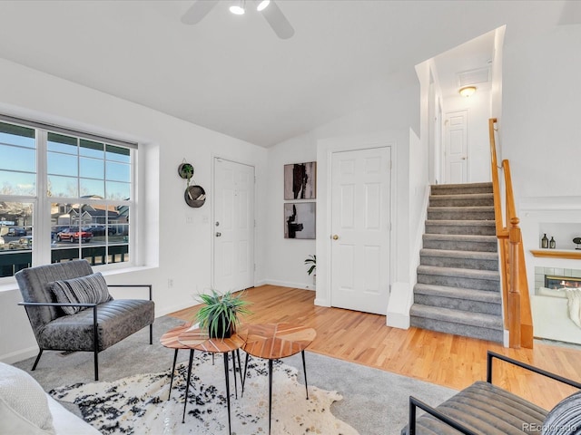 living room featuring ceiling fan, vaulted ceiling, and hardwood / wood-style floors