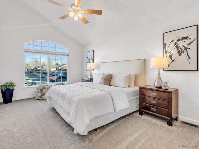 bedroom with ceiling fan, light colored carpet, and high vaulted ceiling