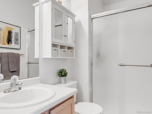 bathroom featuring toilet, walk in shower, and vanity