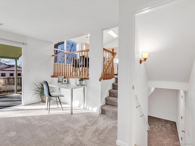 staircase with lofted ceiling and carpet floors