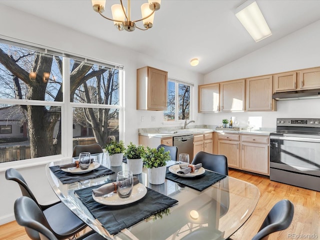 kitchen with vaulted ceiling, an inviting chandelier, hanging light fixtures, appliances with stainless steel finishes, and light brown cabinetry