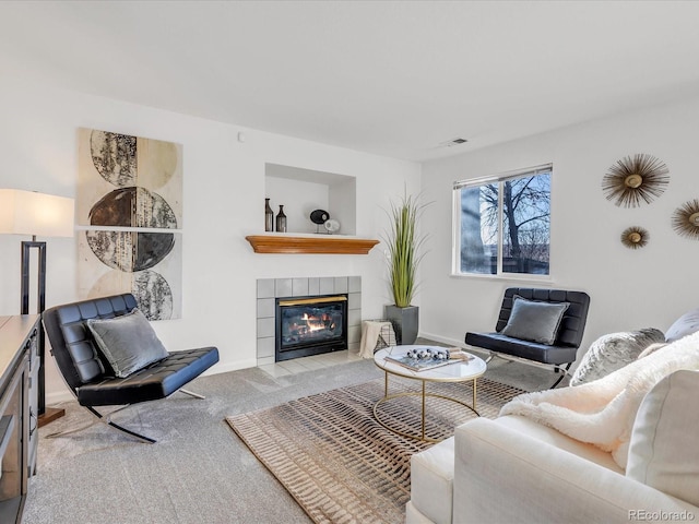 carpeted living room featuring a fireplace