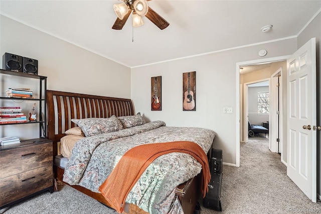 bedroom featuring carpet flooring, ceiling fan, and crown molding