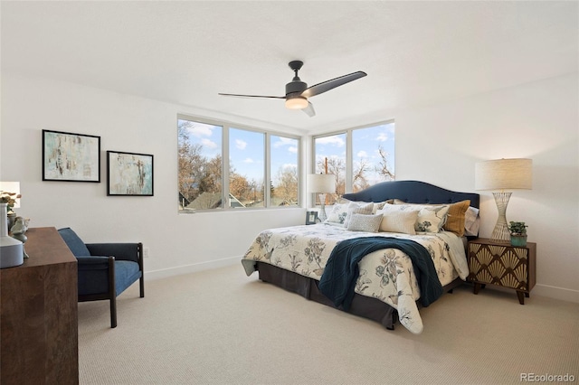 bedroom with ceiling fan and light colored carpet