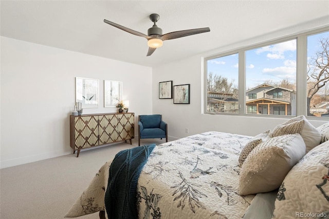 bedroom featuring multiple windows, carpet floors, and ceiling fan