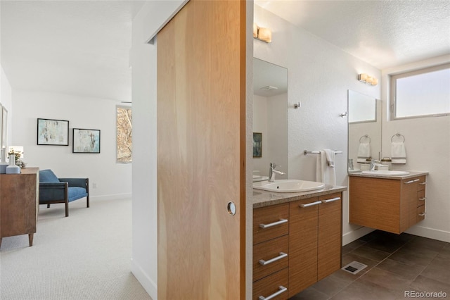 bathroom featuring vanity and a textured ceiling