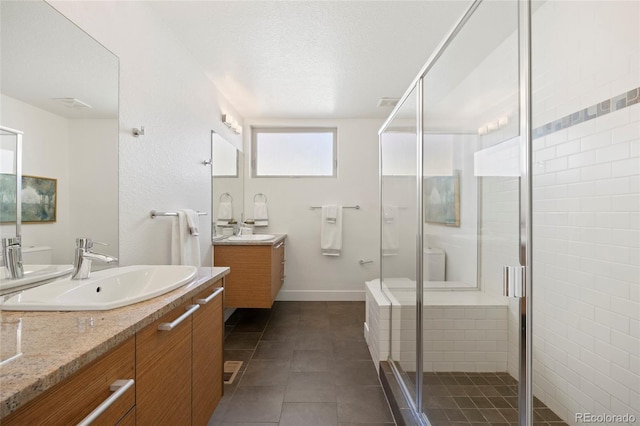 bathroom featuring vanity, tile patterned floors, a textured ceiling, and a shower with shower door