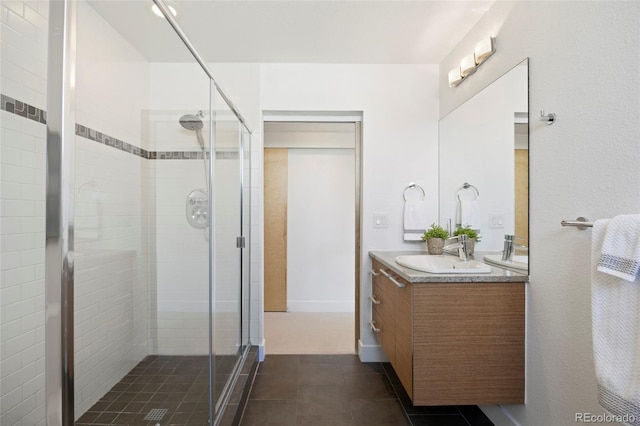 bathroom featuring tile patterned floors, vanity, and an enclosed shower