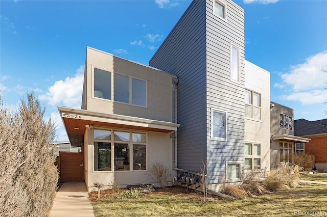 rear view of house with stucco siding