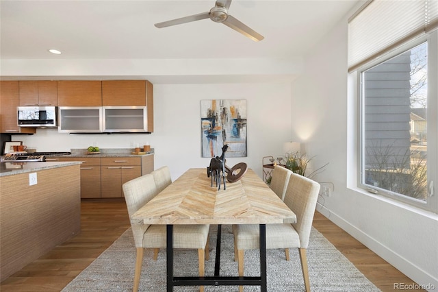 dining space featuring dark wood-type flooring, recessed lighting, ceiling fan, and baseboards