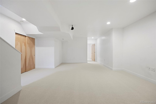 unfurnished room featuring light carpet, baseboards, and recessed lighting