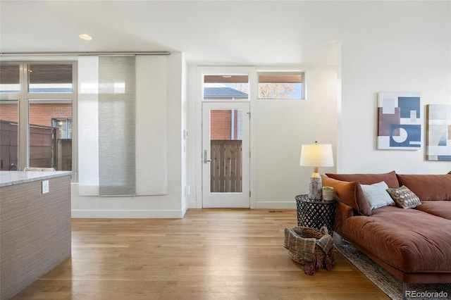 living room with light wood-style flooring and baseboards