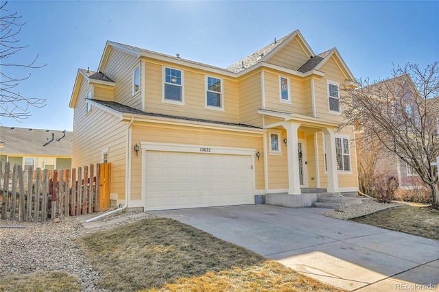 view of front of home featuring an attached garage, fence, and concrete driveway