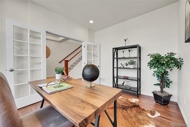 office space featuring recessed lighting, visible vents, baseboards, and wood finished floors