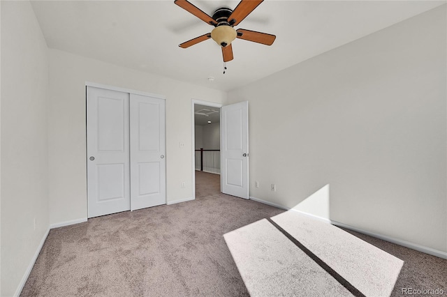 unfurnished bedroom with a closet, carpet flooring, and baseboards