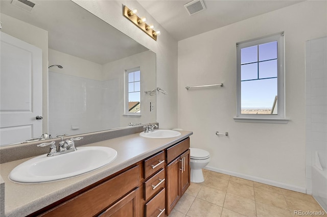 bathroom featuring toilet, visible vents, and a sink