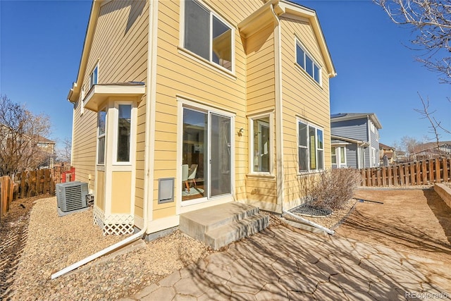 exterior space featuring entry steps, cooling unit, and fence