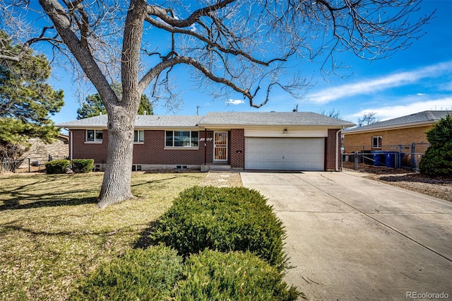 single story home featuring brick siding, fence, concrete driveway, a front yard, and an attached garage