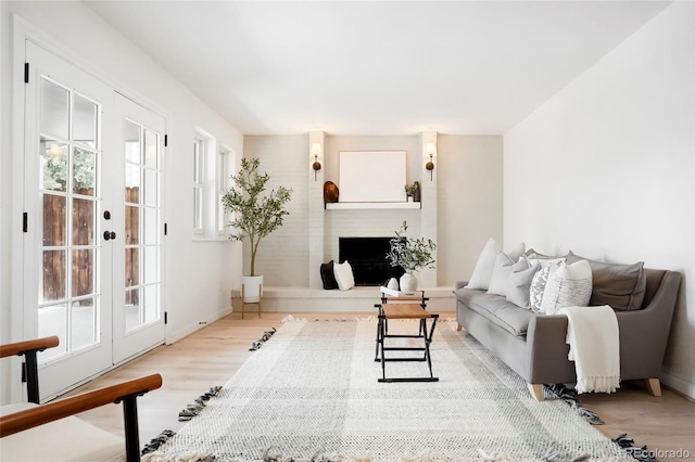 129 Gordon Pl, Castle Rock, CO 80104 - living room with french doors, a fireplace with raised hearth, and wood finished floors