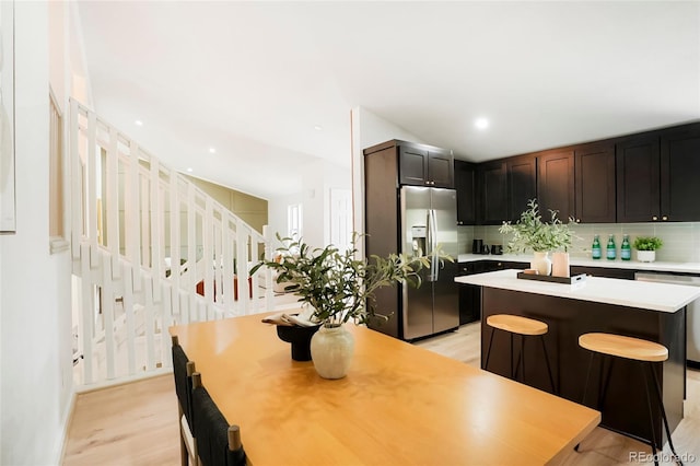 129 Gordon Pl, Castle Rock, CO 80104 - kitchen featuring light wood-style floors, light countertops, tasteful backsplash, and stainless steel appliances