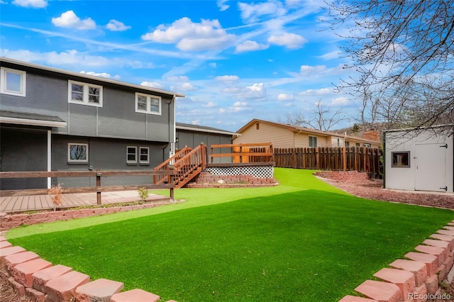 129 Gordon Pl, Castle Rock, CO 80104 - view of yard with fence, a wooden deck, and an outdoor structure