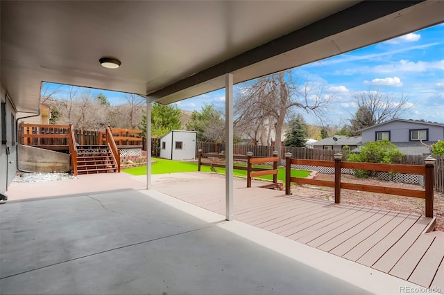 129 Gordon Pl, Castle Rock, CO 80104 - view of patio with a deck, a fenced backyard, a storage shed, an outbuilding, and a residential view