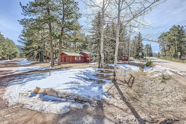 snowy yard with an outbuilding
