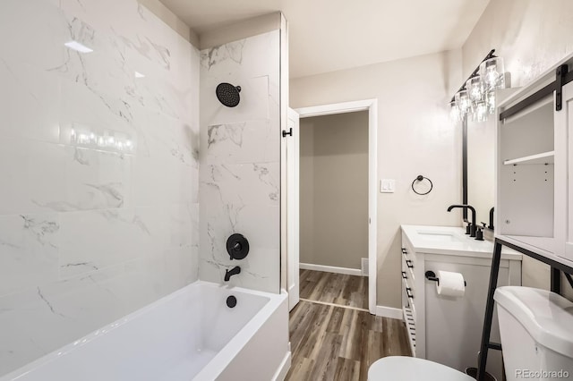 full bathroom featuring toilet,  shower combination, wood finished floors, and vanity