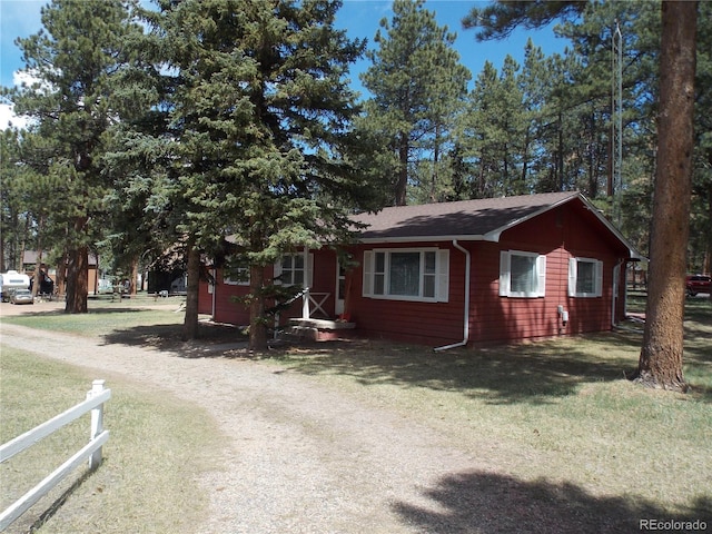 view of front of home with a front lawn and fence