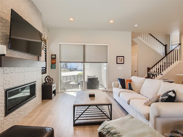 living room featuring a fireplace and light hardwood / wood-style floors