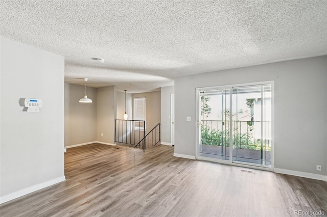14590 E 13th Ave, Aurora, CO 80011 - empty room with wood finished floors and a textured ceiling