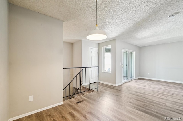 14590 E 13th Ave, Aurora, CO 80011 - empty room with wood finished floors and a textured ceiling